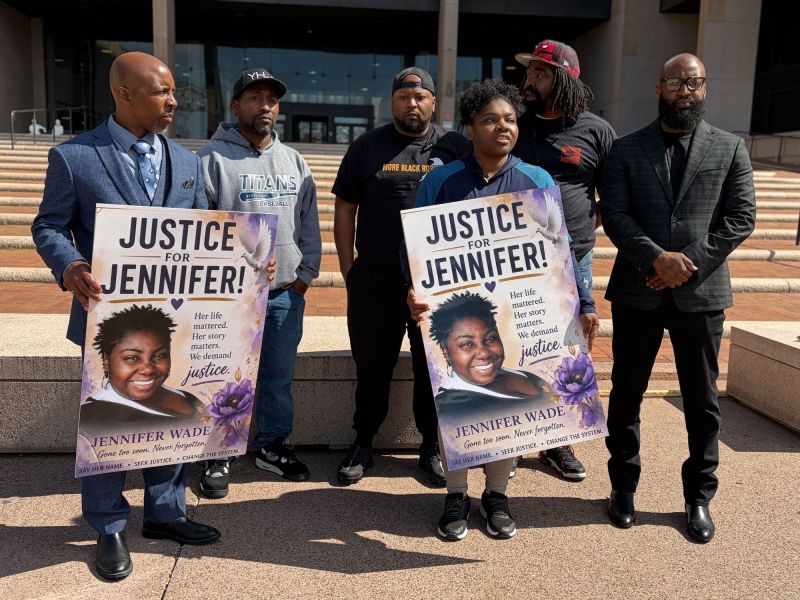 A group of people on the steps of a courthouse.