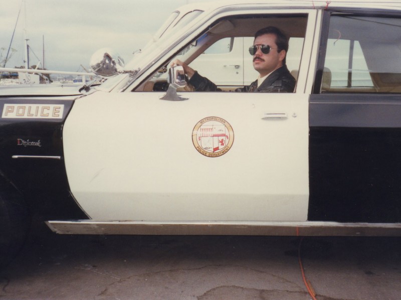 A man in a police cruiser